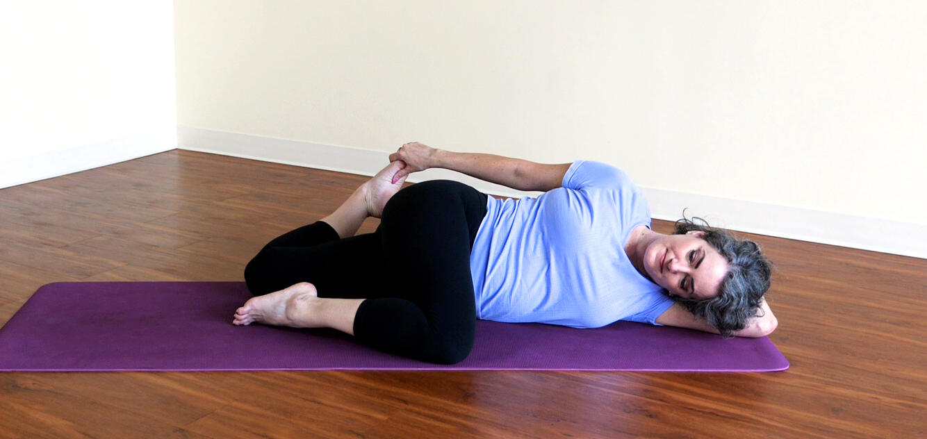 Sage in a yoga pose: both knees bent from a belly-down twist