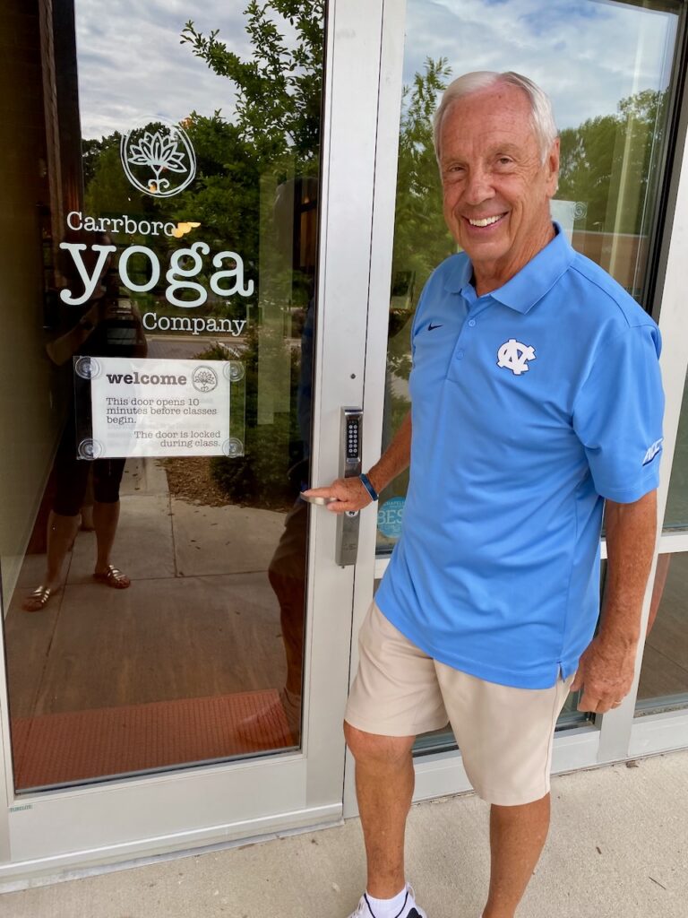 Basketball Hall of Fame Coach Roy Williams at the door of Carrboro Yoga