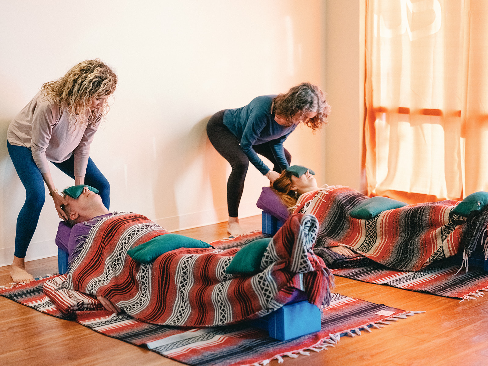 Sage Rountree and Alexandra DeSiato in a restorative yoga workshop