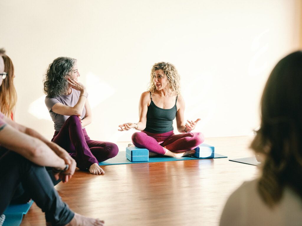 Sage Rountree and Alexandra DeSiato chat in yoga teacher training