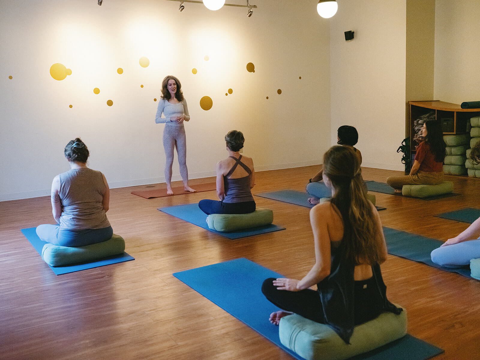 Sage Rountree talks to students seated on mats