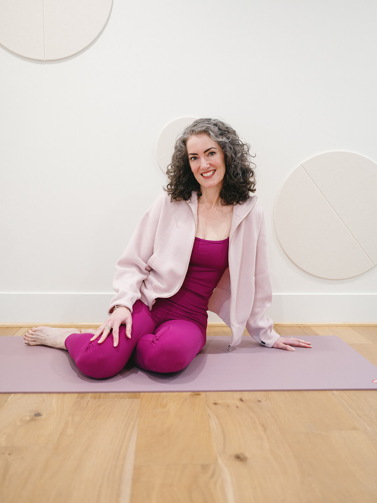 Sage Rountree | Lifestyle Sage Rountree on a yoga mat in her home studio