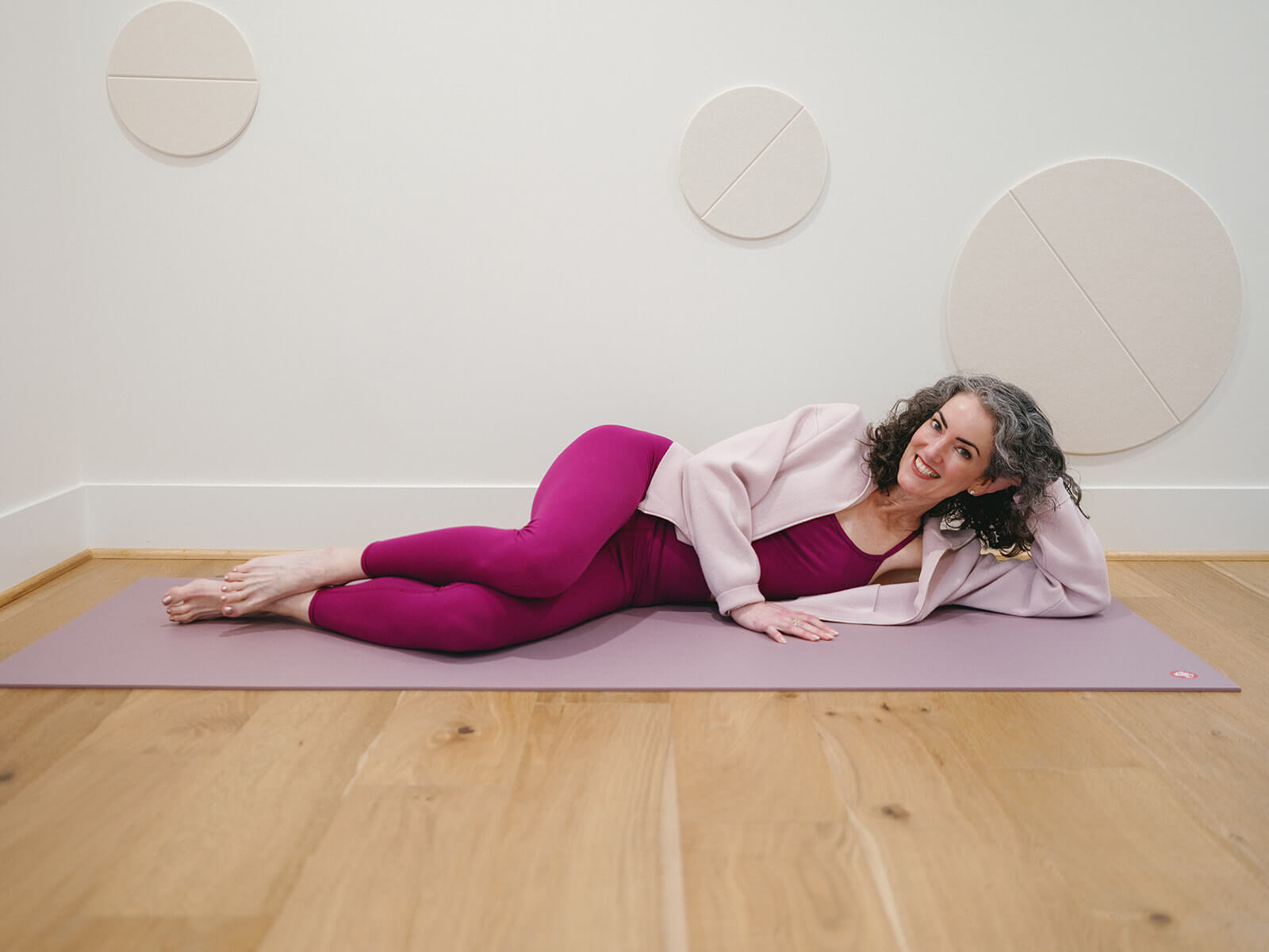 Sage Rountree | Lifestyle Sage Rountree reclines on a yoga mat