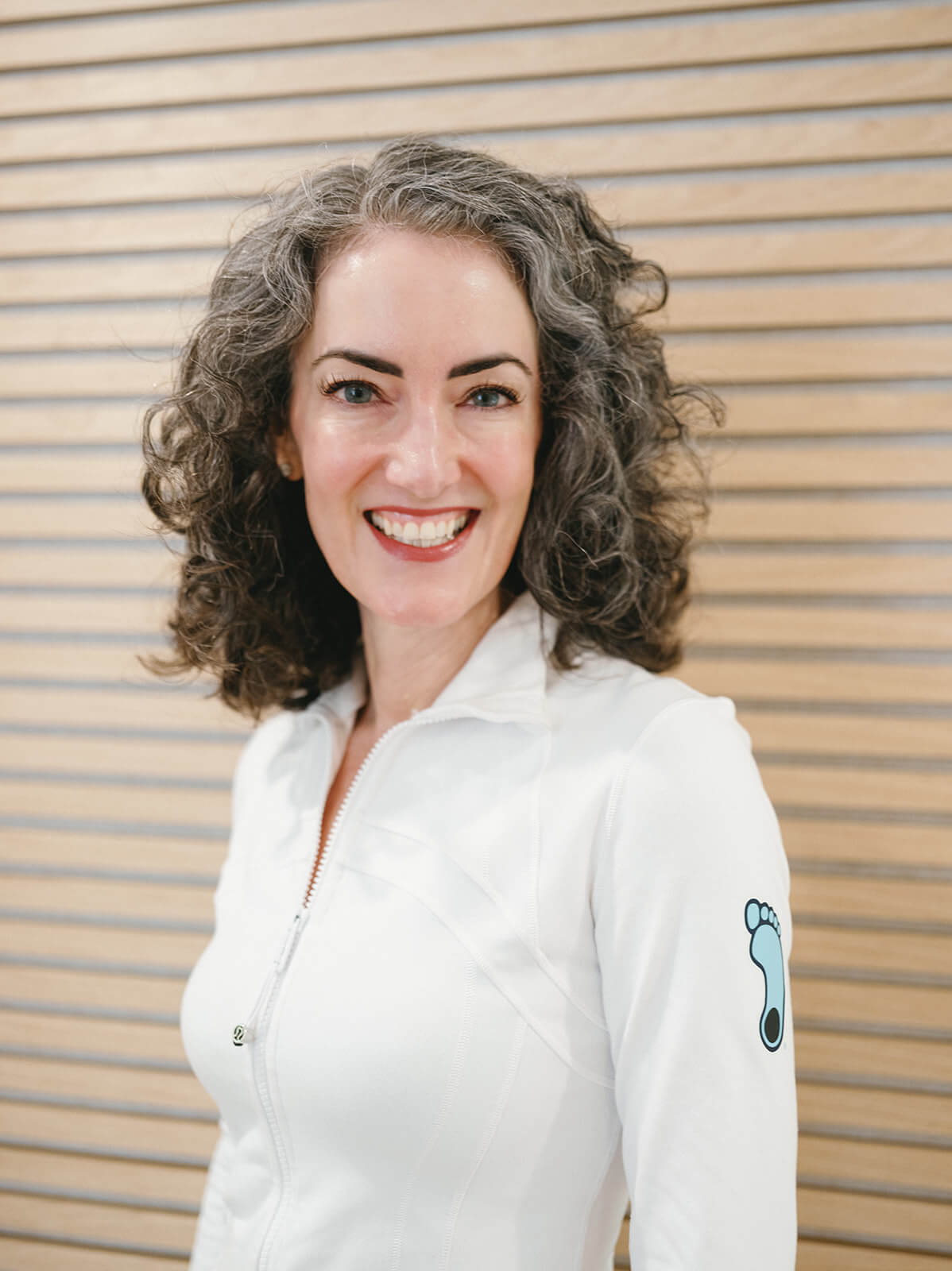 Sage Rountree stands in her office wearing a UNC Tar Heels jacket